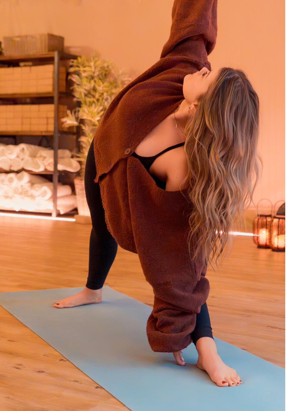 Inside Maitri Yoga Studio in Crowthorne — warm peach walls, wood floors, rolled towels